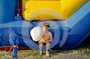 Cute small boy enjoying a stick of candy floss