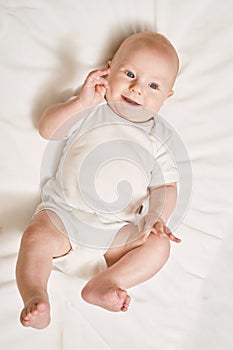 Cute small boy lying at bed. Childhood concept photo