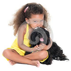 Cute small girl kissing her pet dog