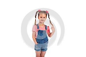 Cute small girl smailing and pulling her hair in the air,  on white background