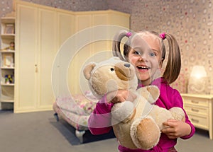 Cute small girl with toy beart