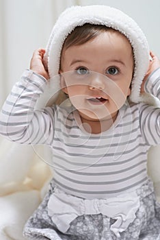 Cute, smile and portrait of baby with a blanket for playing, sitting and having fun at home. Happy, excited and face of