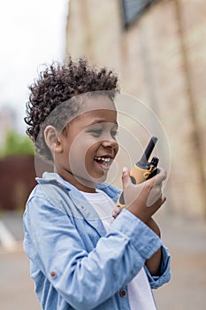 cute smiling afro boy with portable