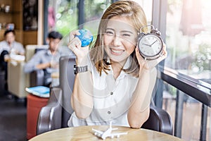 Cute smiling asia girl with globe and alarm clock