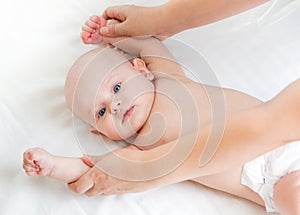 Cute smiling baby gymnastic practice