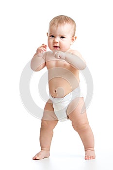 Cute smiling baby learning to walk. Kid weared diaper Isolated on white background.