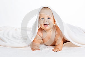 Cute smiling baby lying on towel isolated on white