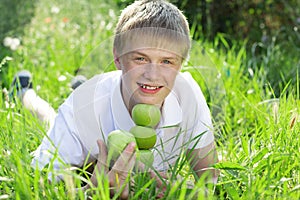 Cute smiling blonde teen boy with pyramid of green