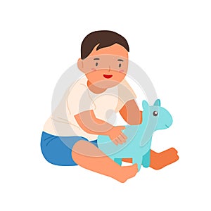 Cute smiling child playing with soft toy vector flat illustration. Happy little boy sitting hugging plaything isolated