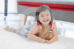 Cute smiling down syndrome girl in living room photo