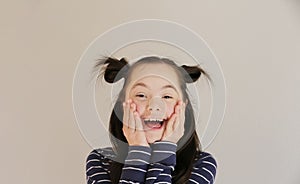 Cute smiling girl isolated on the grey background