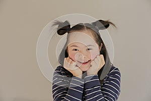 Cute smiling girl isolated on the grey background