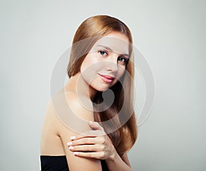 Cute smiling girl portrait. Young woman with healthy hair and clear skin on white background