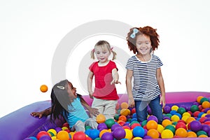 Cute smiling girls in sponge ball pool