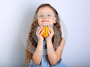 Cute smiling happy kid girl with curly hair style holding the ci