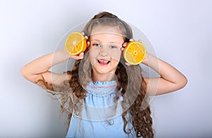 Cute smiling happy kid girl with curly hair style holding citrus