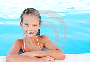 Cute smiling happy little girl child in swimming pool