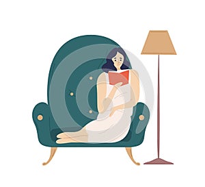 Cute smiling lady sitting in comfy armchair and reading fiction book. Adorable young woman spending weekend at home