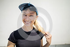 Cute smiling and laughing young blonde woman, exercising in city outdoor, lifestyle portrait.