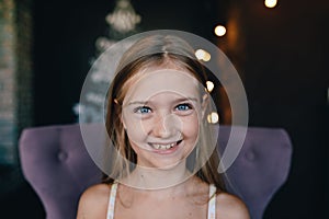 Cute smiling little girl on the background of Christmas decorations