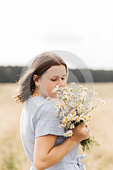 Cute smiling little girl with flower wreath on the meadow. Portrait of adorable small kid outdoors