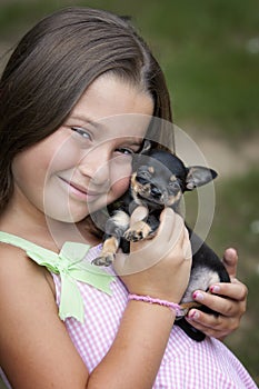 Cute smiling little girl with puppy