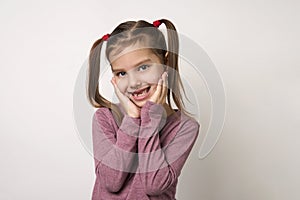 Cute smiling preschool girl portrait on white background