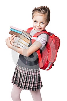 Cute smiling schoolgirl in uniform standing on