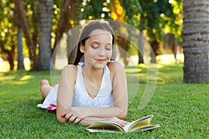 Cute smiling teen girl reading book