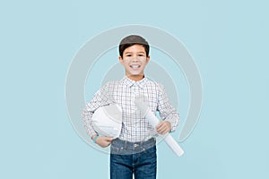 Cute smiling young Asian boy with helmet aspiring to be future engineer