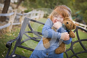 Cute Smiling Young Girl Hugging Her Teddy Bear Outside