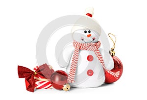 Cute snowman toy, candies and red Christmas balls isolated on white