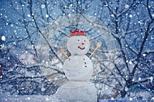 Cute snowmen with - gift presents standing in winter Christmas landscape. New year gift. Snowman with shopping bag -