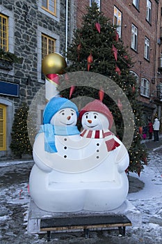 Cute snowmen statues and Christmas tree decorating a popular touristic sector