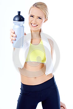 Cute sporty blond woman holding water bottle