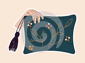 Cute sticker of hand holding a pillow sewed with flowers on cloth