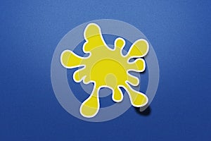 Cute sticker of yellow splash paint on gritty blue background.