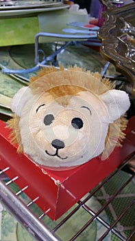 Cute stuffed animal face on display in a thrift store