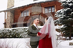 Cute stylish couple on wedding day. Bride and groom meet for the first time. First look. Winter wedding on snowfall with