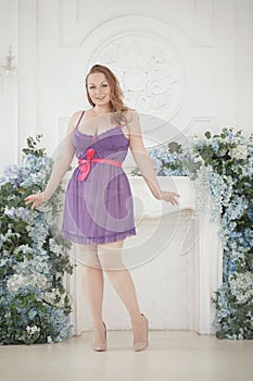 Pretty woman plus size in purple cute lingerie dress babydoll style on white studio room background alone. full length