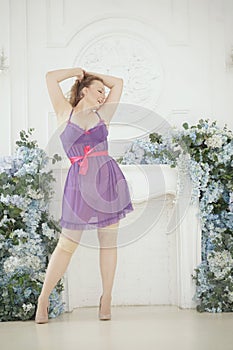 Pretty woman plus size in purple cute lingerie dress babydoll style on white studio room background alone. full length