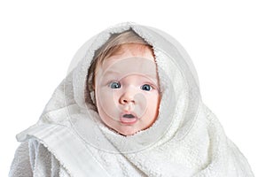 Cute surprised Baby in fluffy towel after bathing isolated on white background. Concept of hygiene, childcare