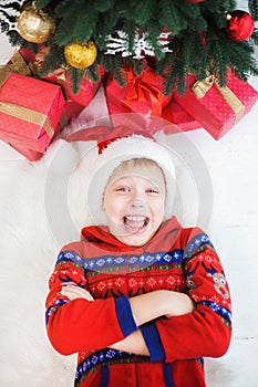 Cute surprised little child in holiday christmas interior