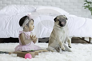 Cute Sweet Adorable Asian Baby wearing white dress Sitting on white bed smiling and playing with happiness emotional