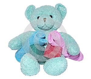 Cute teddy bear with bars of soap and facecloths