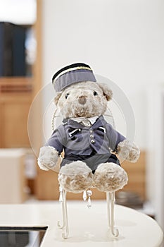 Cute teddy bear in bell boy uniform