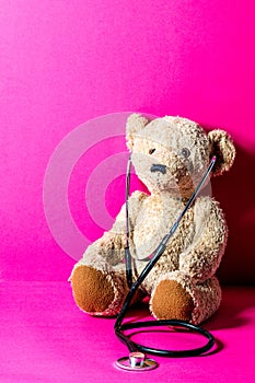 Cute teddy bear with a stethoscope for child healthcare learning