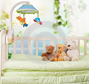 Cute Teddy bears in baby`s bed