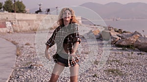 Cute teen girl dancing on tne beach