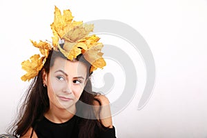 Cute teen girl with leaves in hair rolling eyes